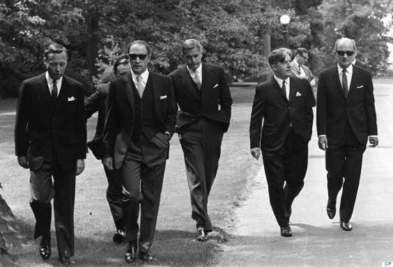 Prime Minister Pierre Trudeau (second from left) wearing dark glasses, arrives with members of his new cabinet for swearing in ceremonies at Government House in Ottawa, July 6, 1968. Saturday. Left to right are: James Richardson, minister without portfolio, D.C. Jamieson, (partly hidden), minister without portfolio, Trudeau, Justice Minister John Turner, Jean Marchand, Forestry Minister, and Gerard Pelletier, State Secretary. Ten years after his death, and more than four decades after it was taken, the photo of Pierre Trudeau striding up the drive at Rideau Hall - flanked by his dark-suited cabinet-to-be - still packs a blast of movie-star, hipster cool. THE CANADIAN PRESS/Doug Ball