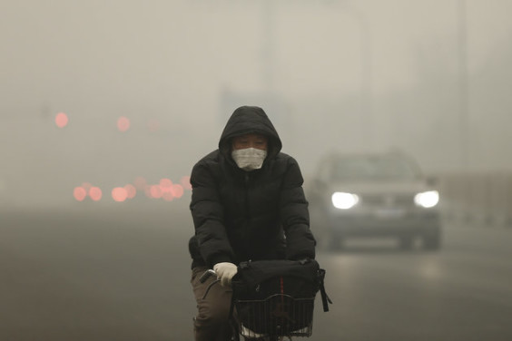 BEIJING, CHINA - DECEMBER 01: A man rides a bicycle on a day of heavy pollution on December 1, 2015 in Beijing, China. China's capital and many cities in the northern part of the country recorded the worst smog of the year with air quality devices in some areas unable to read such high levels of pollutants. Levels of PM 2.5, considered the most hazardous, crossed 600 units in Beijing, nearly 25 times the acceptable standard set by the World Health Organization. (Photo by Lintao Zhang/Getty Images)