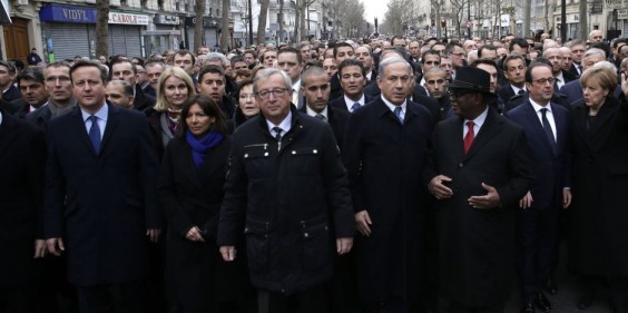 French President Hollande is surrounded by heads of state as they attend the solidarity march in the streets of Paris