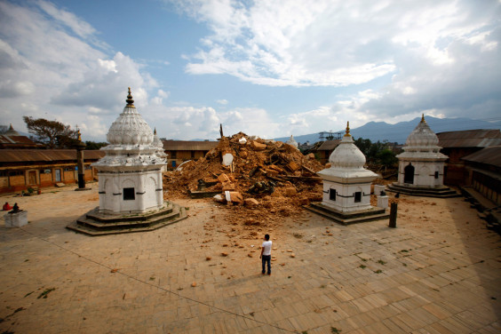 In this combination of two photos, on left, people look at the debris of one of the oldest temples after it was damaged in earthquake, in Kathmandu, Nepal, Sunday, April 26, 2015, as on right a person looks at the same place after the debris of the temple complex was cleared, in Katmandu, Nepal, Wednesday, March 2, 2016. The violence of the 7.8-magnitude earthquake left countless towns and villages across central Nepal in a shambles. Almost one year later, a shambles they remain. (AP Photo/Niranjan Shrestha)