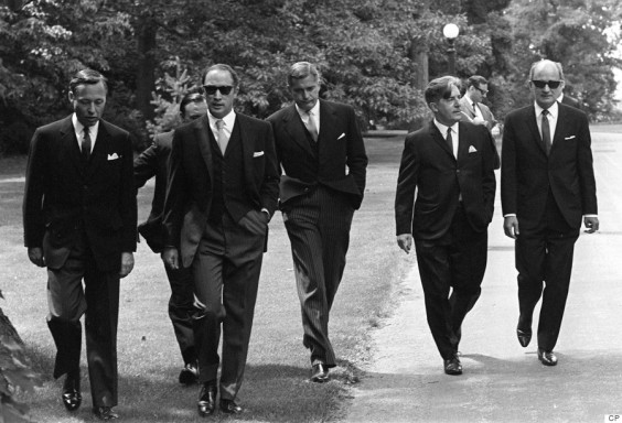 Prime Minister Pierre Trudeau (second from left) wearing dark glasses, arrives with members of his new cabinet for swearing in ceremonies at Government House in Ottawa, July 6, 1968. Saturday. Left to right are: James Richardson, minister without portfolio, D.C. Jamieson, (partly hidden), minister without portfolio, Trudeau, Justice Minister John Turner, Jean Marchand, Forestry Minister, and Gerard Pelletier, State Secretary. Ten years after his death, and more than four decades after it was taken, the photo of Pierre Trudeau striding up the drive at Rideau Hall - flanked by his dark-suited cabinet-to-be - still packs a blast of movie-star, hipster cool. THE CANADIAN PRESS/Doug Ball