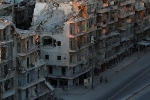 People walk past damaged buildings in the rebel-held Tariq al-Bab neighbourhood of Aleppo, Syria, October 5, 2016. To match Insight MIDEAST-CRISIS/SYRIA-ALEPPO REUTERS/Abdalrhman Ismail NYTCREDIT: Abdalrhman Ismail/Reuters