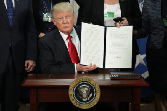 WASHINGTON, DC - JANUARY 25: (AFP OUT) U.S. President Donald Trump (C) displays one of the two executive orders he signed during a visit to the Department of Homeland Security January 25, 2017 in Washington, DC. Trump signed two executive orders related to domestic security and to begin the process of building a wall along the U.S.-Mexico border. (Photo by Chip Somodevilla/Getty Images)