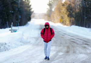 A man who said his name was Abdullah and that he was a student from Yemen walks towards the U.S.-Canada border to cross into Hemmingford, Canada, from Champlain in New York, U.S., February 17, 2017. (Christinne Muschi/Reuters)